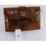 A vintage brown leather snakeskin handbag