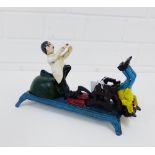 A reproduction novelty cast iron savings bank modelled as a Dentist pulling a Tooth, 23cm long