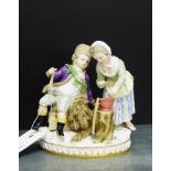 A 19th century Meissen boy and girl figure group, the boy modelled seated upon a sledge with an