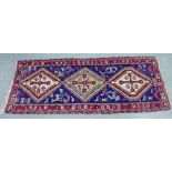 A Kazak type runner with sapphire field and red border, 98 x 260cm