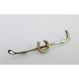 A silver riding crop and horseshoe bar brooch