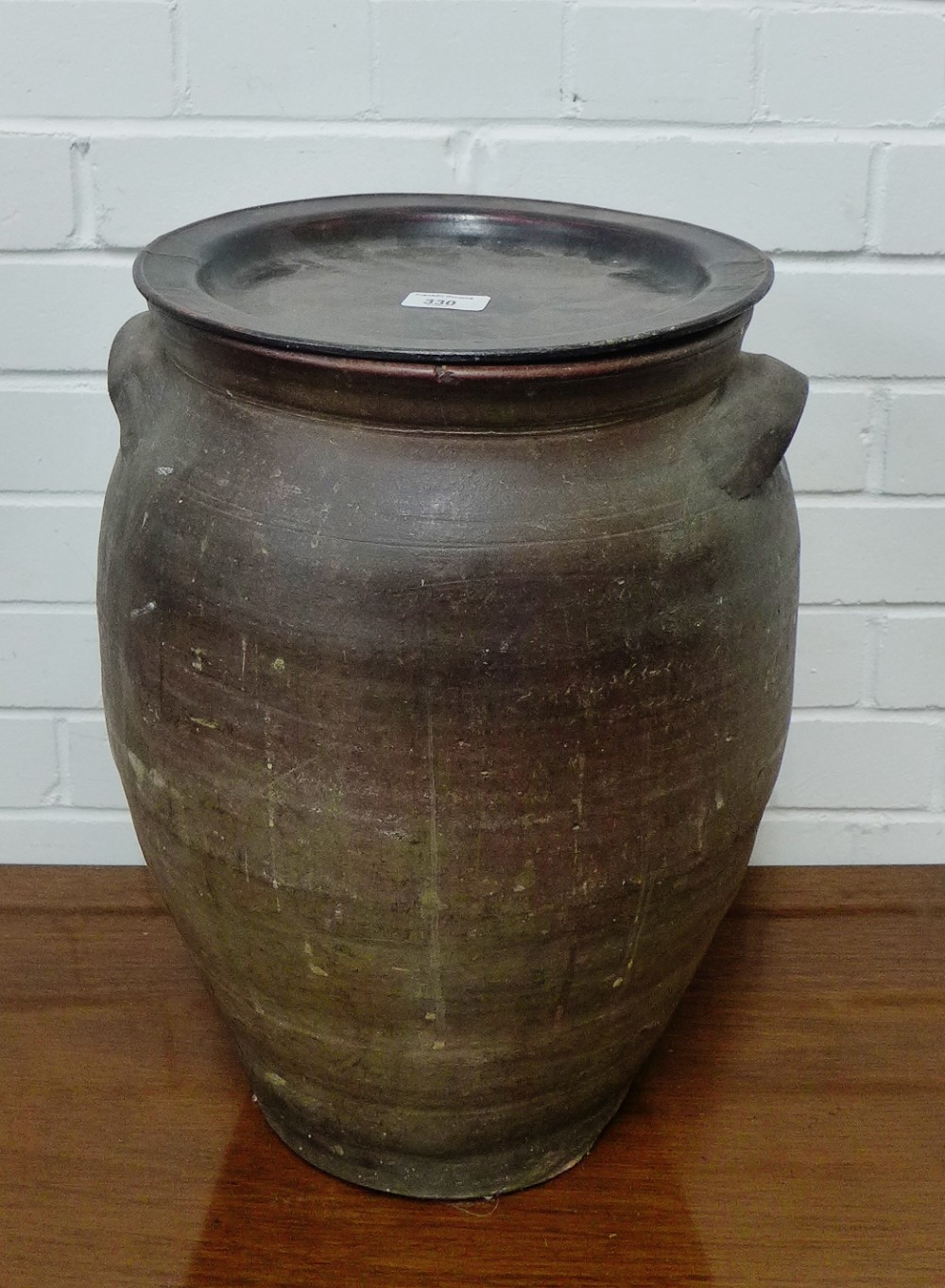 A large stoneware garden planter