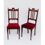 A pair of Edwardian hall chairs, the top rails with pierced heart motif, over vertical splat backs