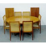 Dyrlund extending dining table with two extra leaves together with a set of six cane back chairs