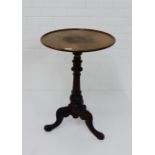 A mahogany table, the circular dished top on turned column and tripod supports, 72 x 48cm