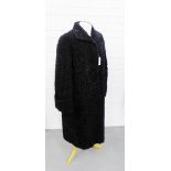 A black Astrakhan coat with turned up sleeves