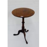 A mahogany table, the circular tilt top on turned column and tripod supports, 70 x 46cm