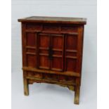 A Chinese chest with distressed painted finish, the rectangular top over two panelled cupboard doors