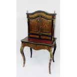 A boullework work cabinet on stand with an arched top over a pair of cupboard doors, on conforming