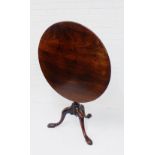 A mahogany table, the circular tilt top on carved tripod supports, 74 x 85cm