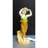 A Royal Worcester blush ivory figure of a female with a tambourine on a naturalistic base with