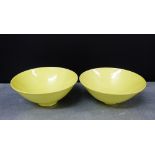 A pair of pale yellow glazed bowls of flaring conical form on a plain foot rim, impressed mark