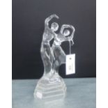 A moulded glass dancing figure group, 28cm high