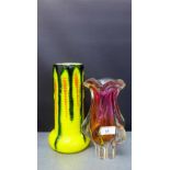 A coloured art glass vase together with a yellow glazed pottery vase with black streaked glaze,