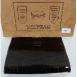 A vintage brown leather crocodile clutch bag, 23cm wide, with a suede interior, containing a small