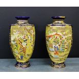 A pair of Moriage Satsuma hexagonal baluster vases, decorated with figures and landscape scene to