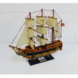 An HMS Bounty model triple masted sailing ship, 32cm high