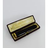 A French cherry amber coloured cheroot holder with gold mounts, in a fitted Palais Royal - Cannes