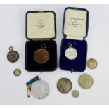 A mixed lot of medals and coins to include a silver 'Home Photographer' merit medal, bronze London