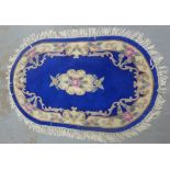 A Chinese wool rug with blue floral field, 152 x 98cm