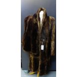 A ladies brown fur coat, together with a brown fur shoulder cape, (2)