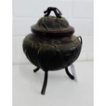 A Chinese bronzed tripod censor and cover, the lid with the handle in the form of a bat, it has a