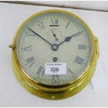 A brass cased ships clock with Roman numerals and subsidiaries seconds dial, 22cm diameter