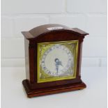 An Elliot of London mantle clock in a burr wood case and on four brass bun feet, 17cm high