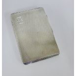 An Art Deco silver cigarette case with engine turned decoration and inscribed 'presented to