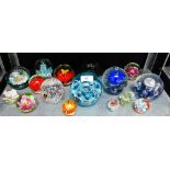 A collection of sixteen glass paperweights to include Caithness 'Myriad' pattern and an Edinburgh