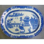 A pearl ware blue and white 'Willow' patterned ashet (restoration to the rim), 53 x 40cm