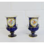 Two Meissen blue ground urn shaped vases with twin handles and gilt edge rims painted with floral