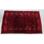 An Iranian rug, the red field with all over medallion pattern within flowerhead and geometric