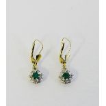A pair of 9 carat gold earrings with emerald and diamond cluster drops