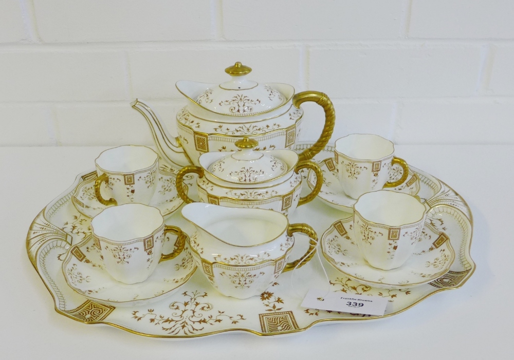 A Royal Crown Derby teaset, the white glazed porcelain with gilt rope twist handles and foliate