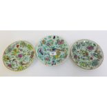 Three Chinese Celadon glazed plates painted in Famille Rose enamels,l with birds, insects, flowers