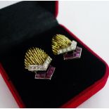 A pair of unmarked gold earrings, circa 1970's, each with a textured fantail panel in the style of