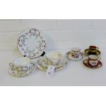 A pair of Royal Crown Derby floral patterned porcelain cup, saucer and side plate trios, together