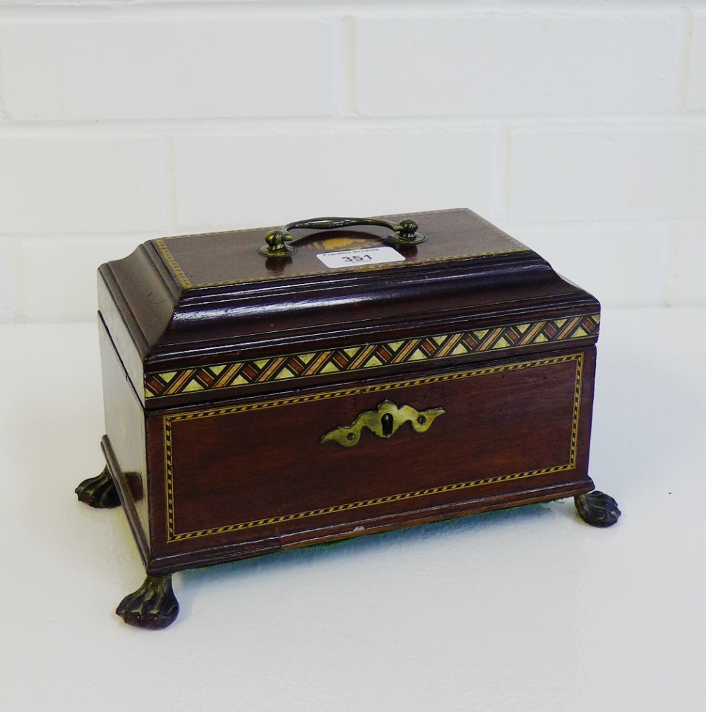 An Edwardian mahogany and chequer banded tea caddy, the rectangular top with shell paterae and brass