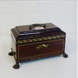 An Edwardian mahogany and chequer banded tea caddy, the rectangular top with shell paterae and brass
