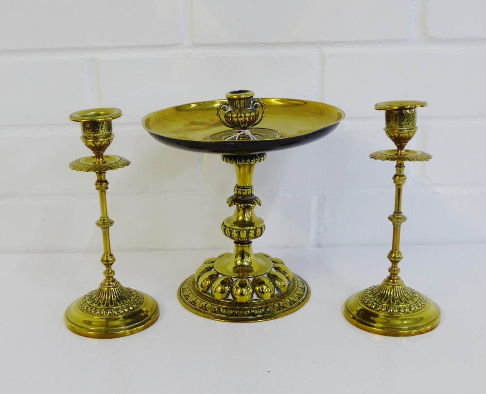 A pair of ornate brass candlesticks, together with another with circular drip tray, tallest 20cm, (