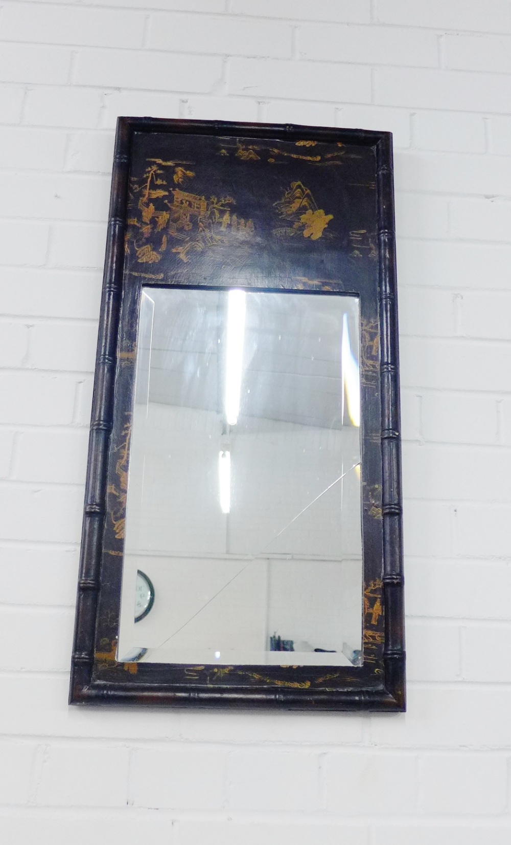 A black and gilt chinoiserie wall mirror, 80 x 40cm