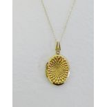 9 carat gold engraved oval locket on 9 carat gold chain