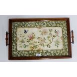 An Edwardian oak tray with inset Japanesque ceramic panel, 55 x 36cm