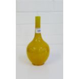 A late 19th / early 20th century Art pottery bottle neck vase with a monochrome ochre glaze, in