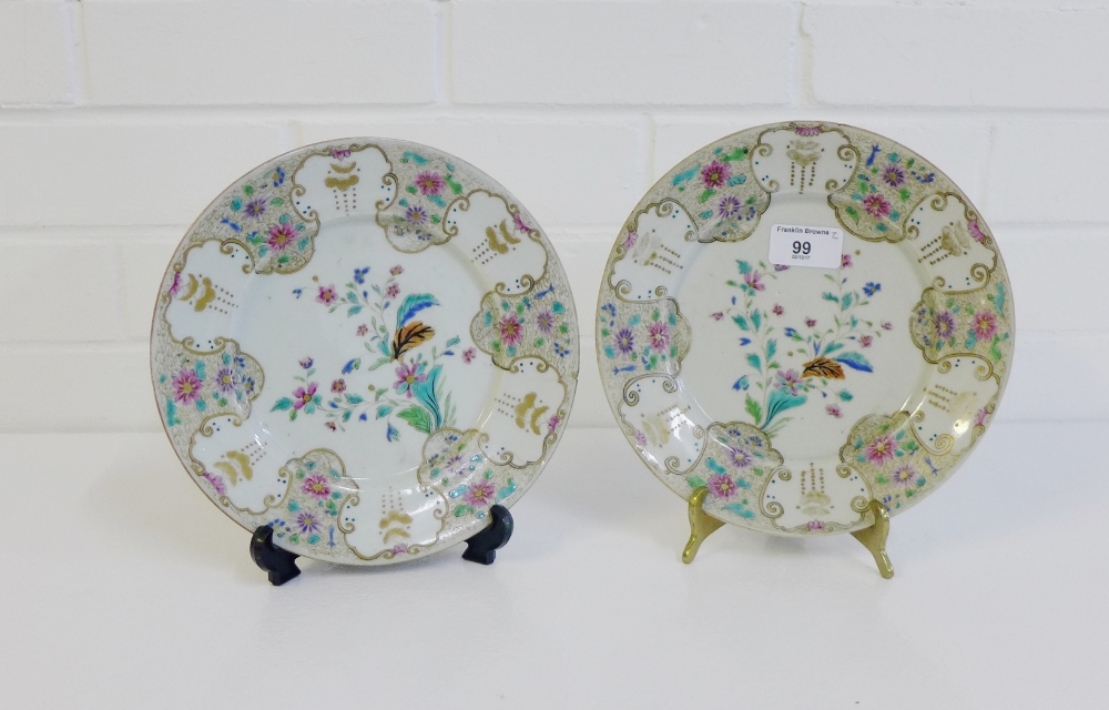 A pair of Chinese porcelain plates, likely 18th century, painted with flowering plants, with a