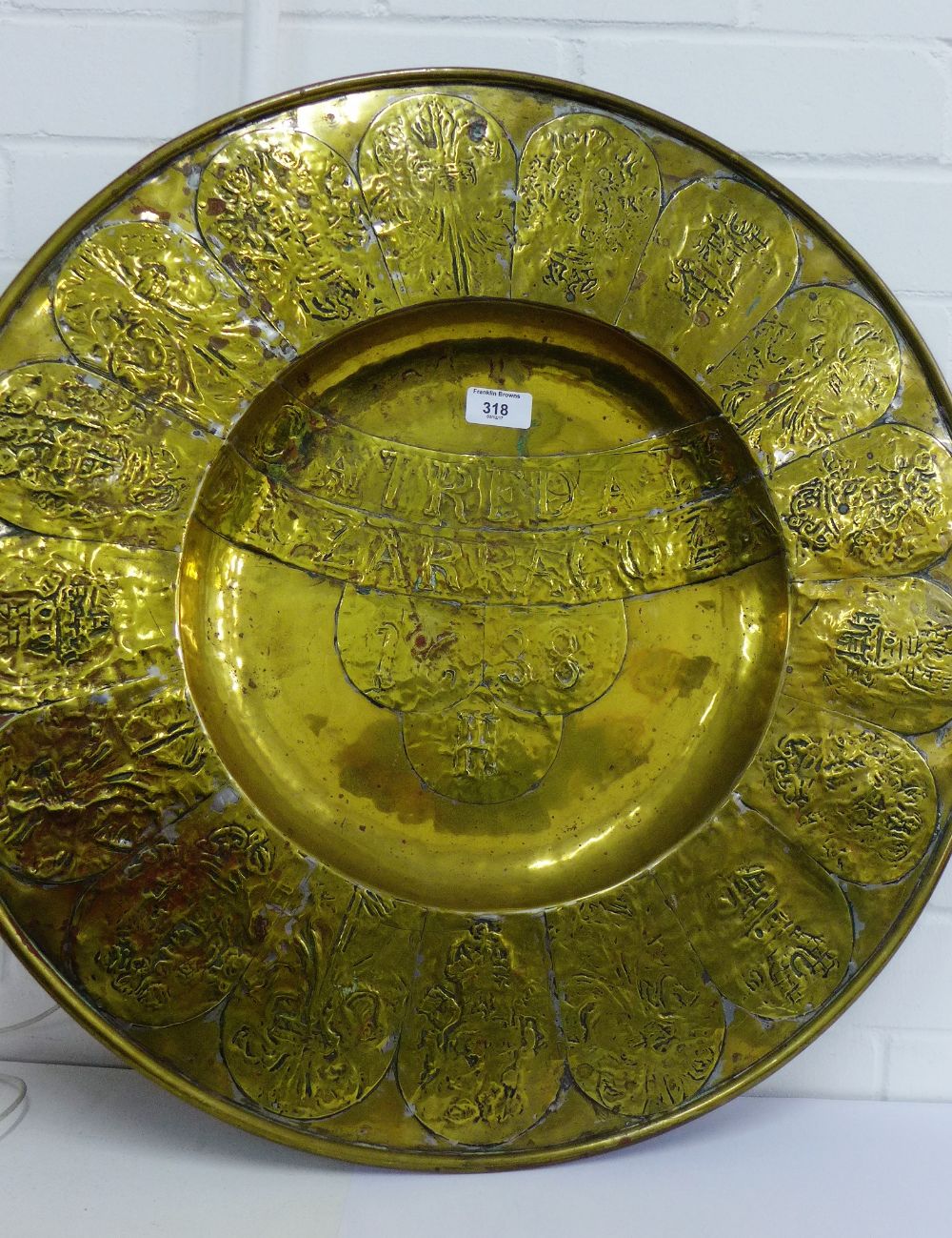 A large brass 'Zarragoza' circular alms dish bearing date 1638, 61cm diameter