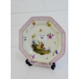 A 19th century Berlin porcelain octagonal plate with pierced gilt lined rim and painted with bird,