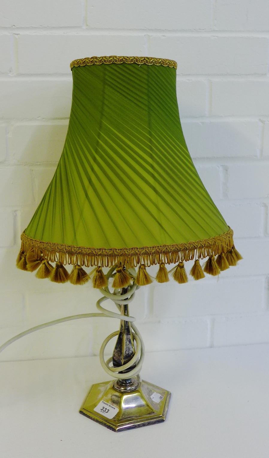 A silver plated octagonal stemmed table lamp and shade