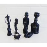 A collection of four African hardwood figures, together with a bird and a bog oak cauldron ink well,